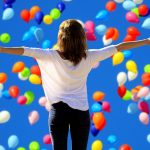 woman feeling free with balloons